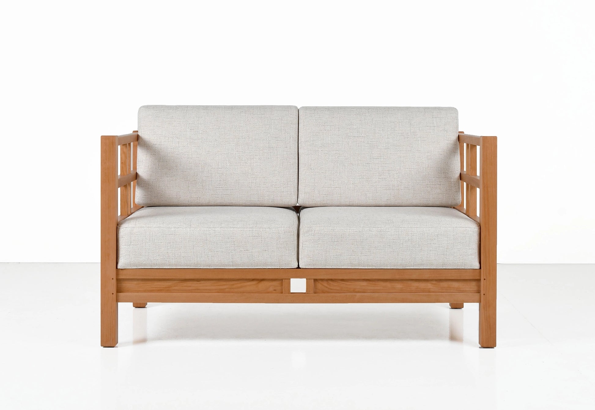 Wooden sofa with light gray cushions on a white background