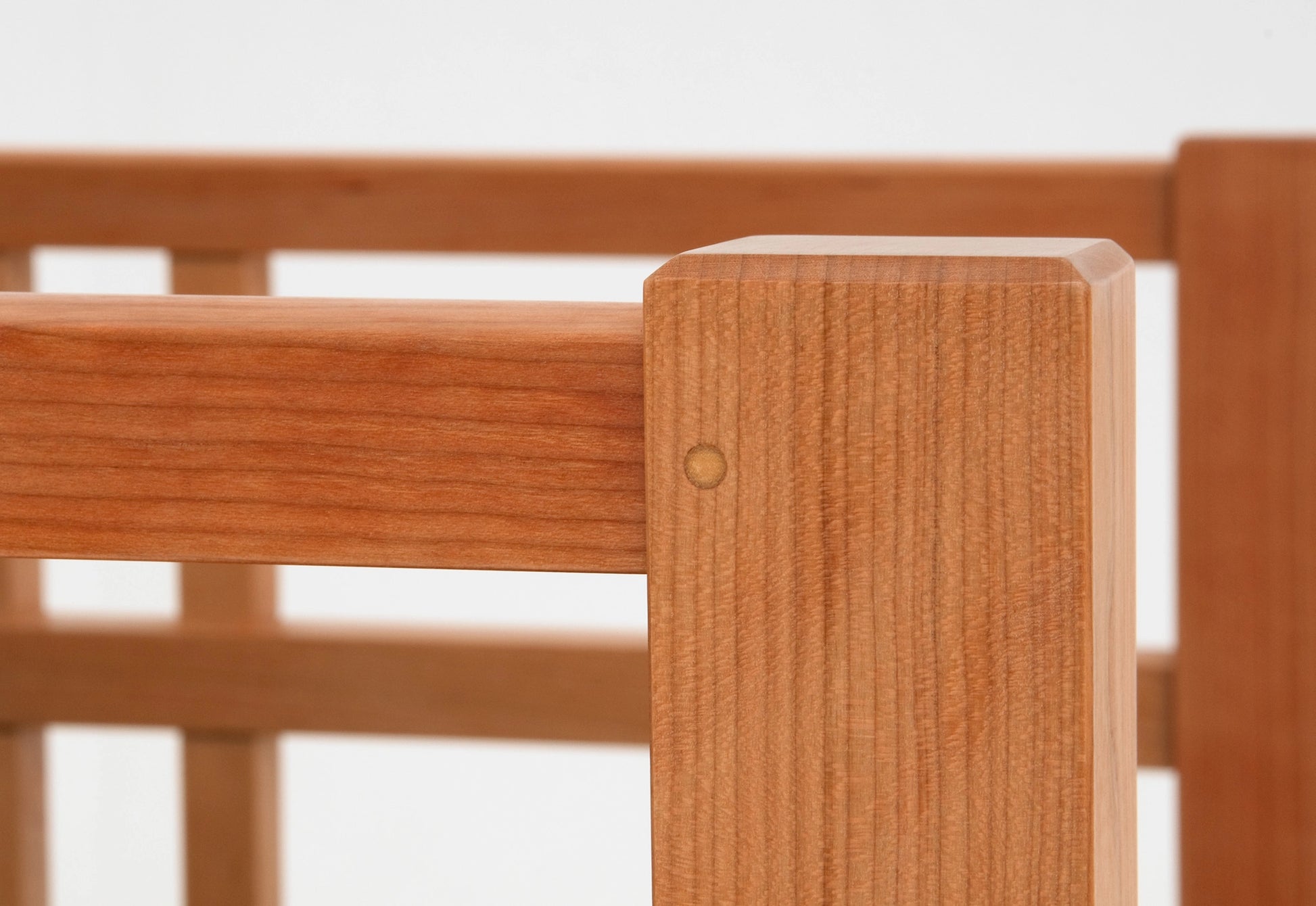 Close-up of a wooden chair with a blurred background