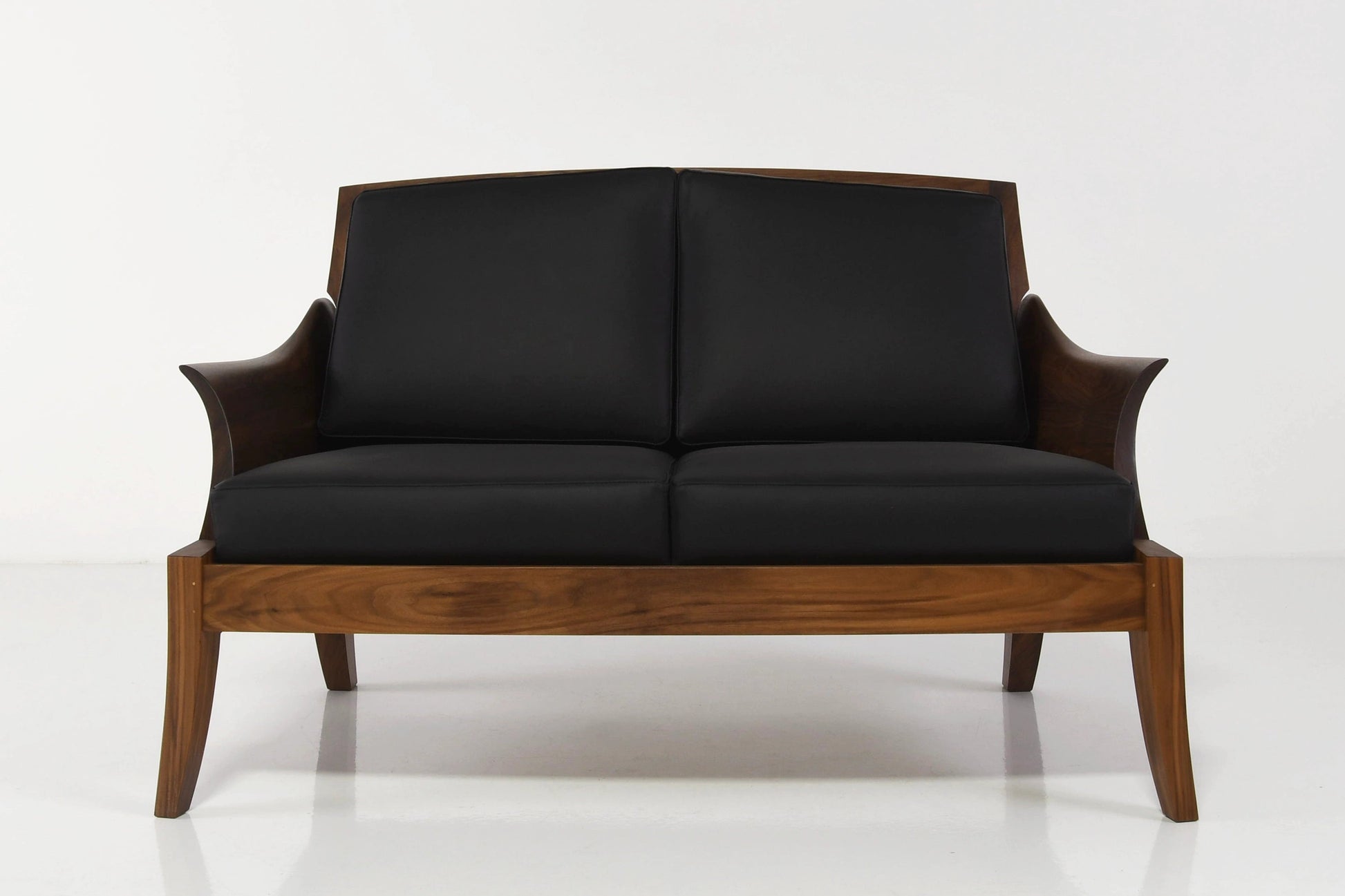 Black sofa with wooden frame on a white background