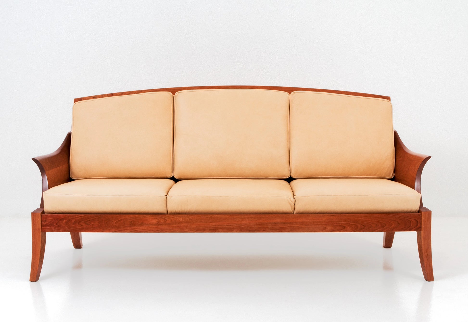 Beige sofa with wooden frame on a white background