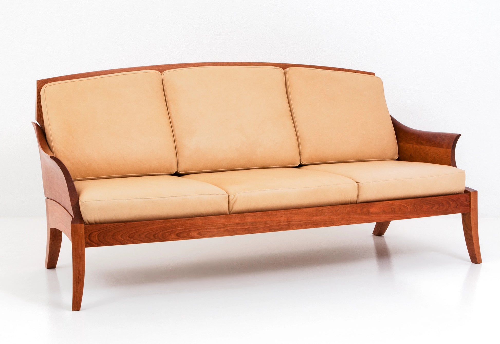 Beige sofa with wooden frame on a white background