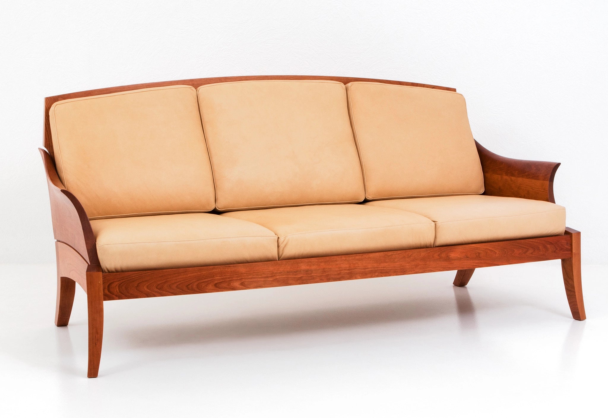 Beige sofa with wooden frame on a white background