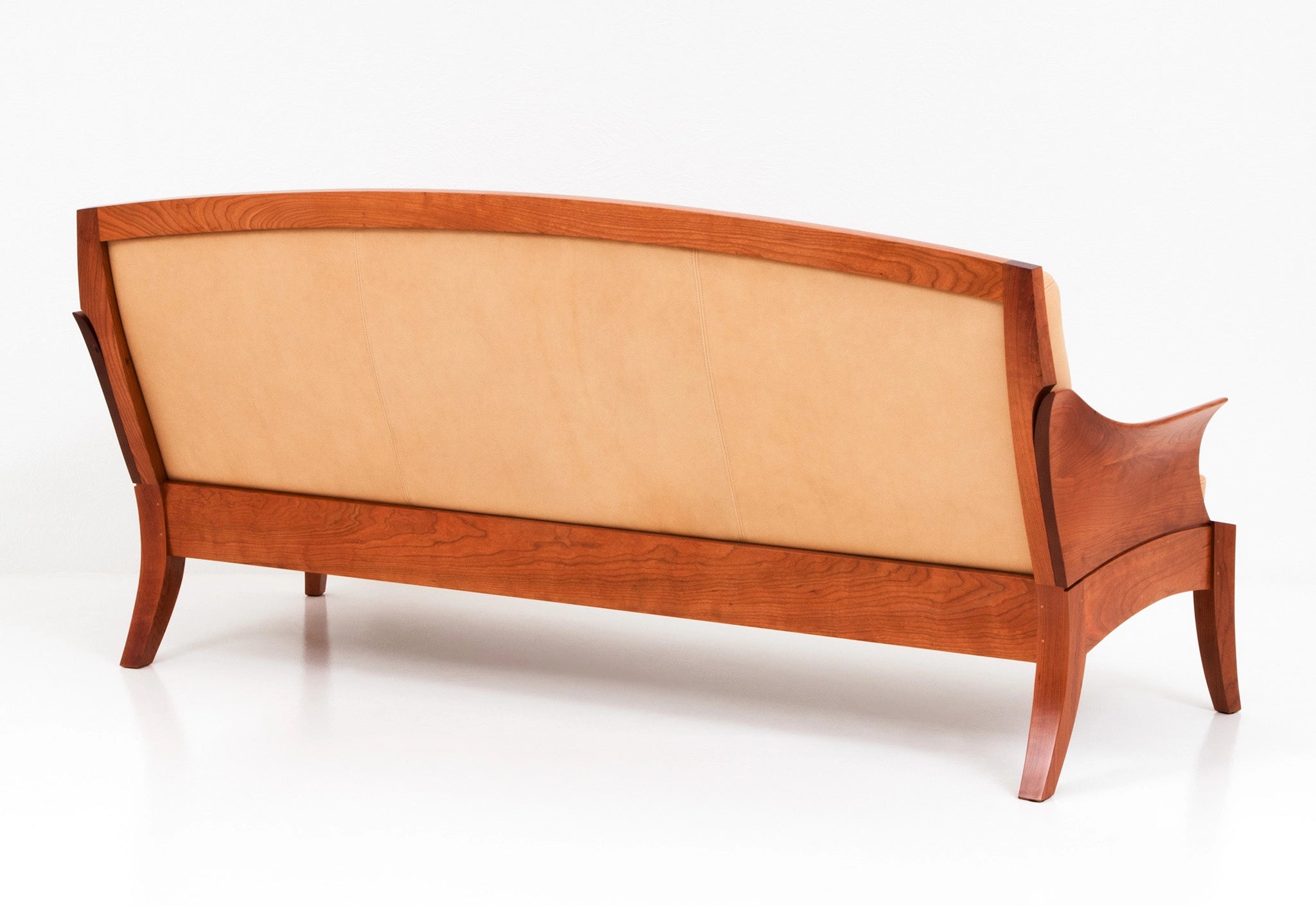 Wooden sofa with beige cushion on a white background