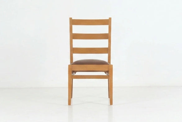 Wooden chair with leather seat on a white background.
