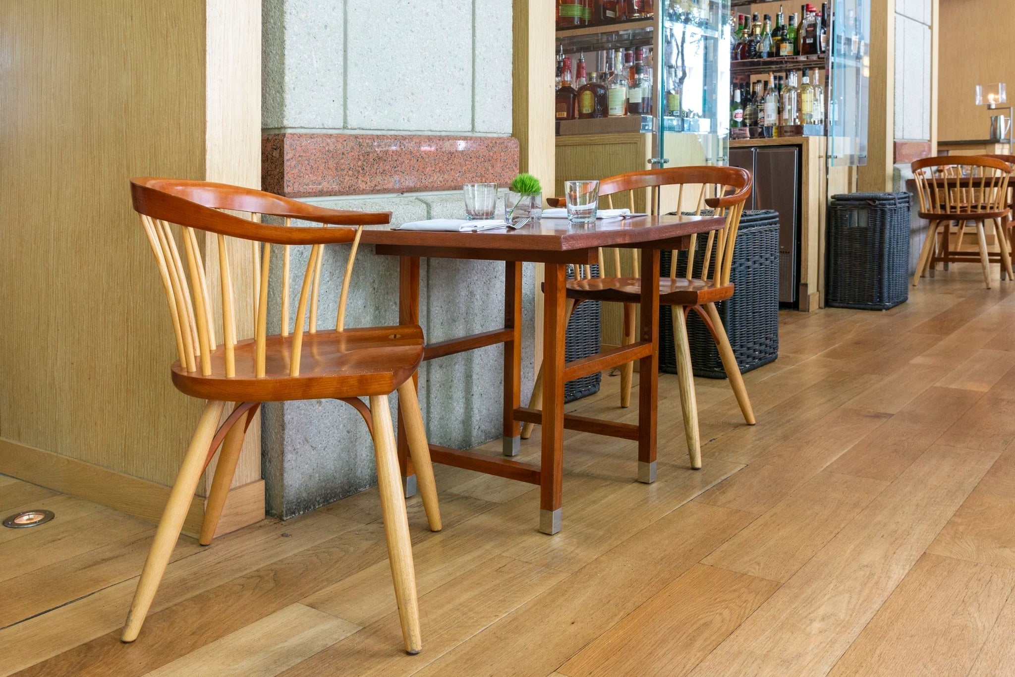 Dining area with wooden table and chairs in a restaurant setting.