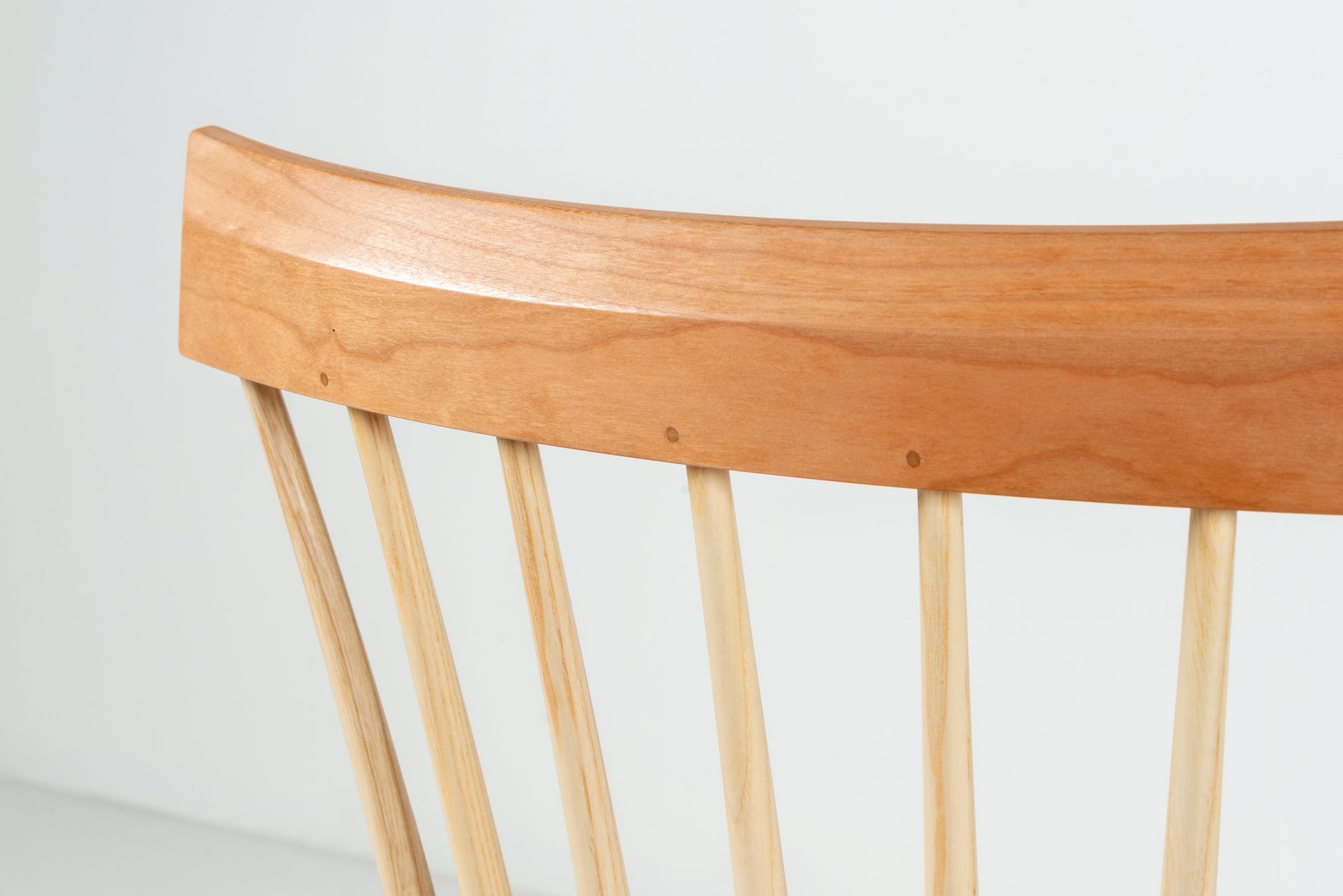 Wooden chair with a curved backrest on a white background