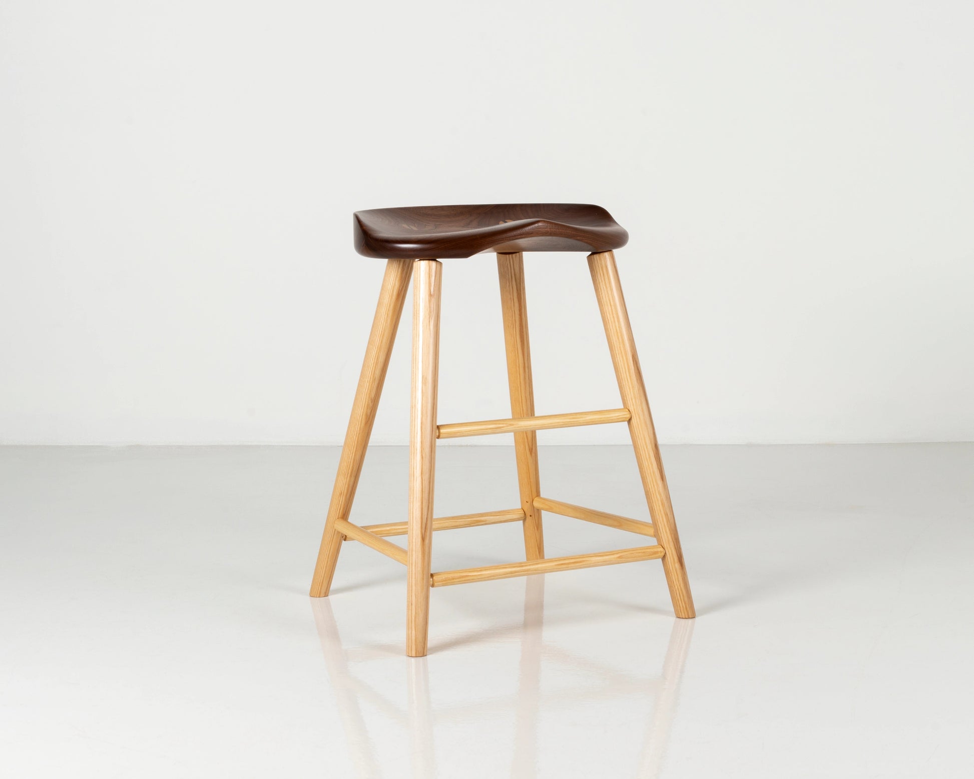 Wooden bar stool with a walnut seat on a white background