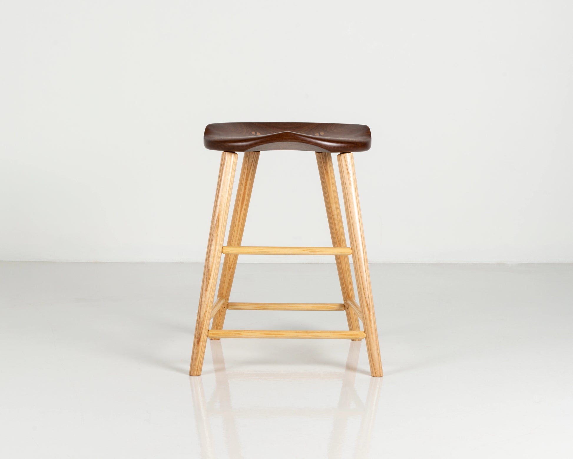 Wooden bar stool with a walnut seat on a white background