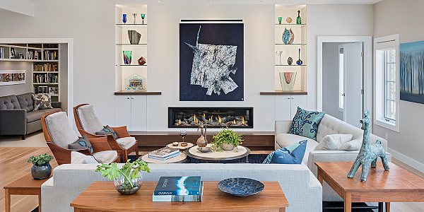 living room with cherry wood lounge chairs, cherry side tables, glass fireplace, recessed shelving