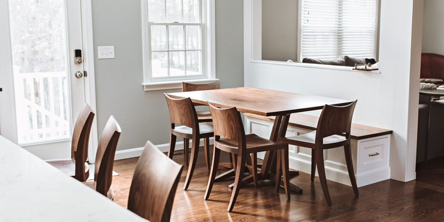 Edo trestle table and auburn chairs in walnut in background in foreground are three auburn stools at kitchen counter
