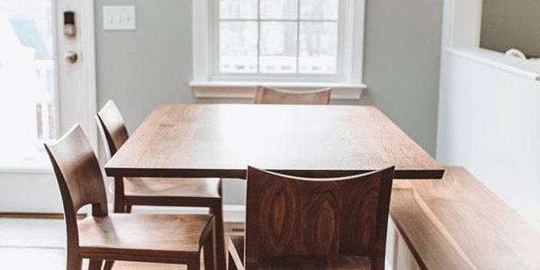 Edo Trestle Table in walnut and Auburn Chairs in walnut in dining scene with window