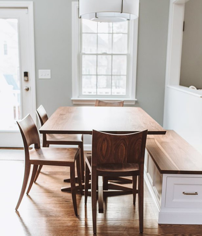 Edo Trestle Table in walnut and Auburn Chairs in walnut in dining scene with window