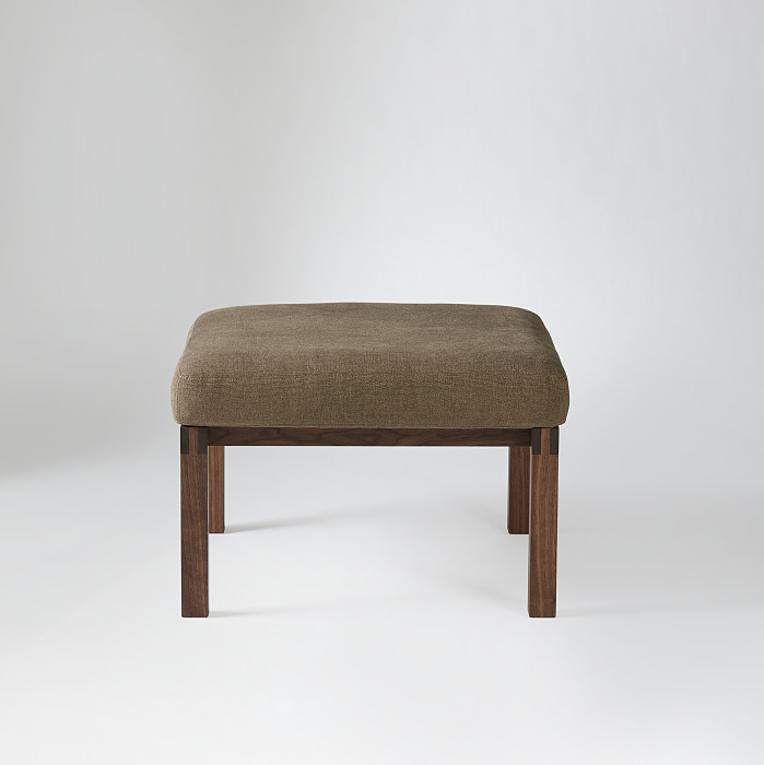 Studio ottoman in walnut and brown fabric upholstery