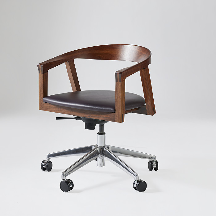3/4 view of NYPL Branch Swivel Chair in walnut with black leather upholstered seat