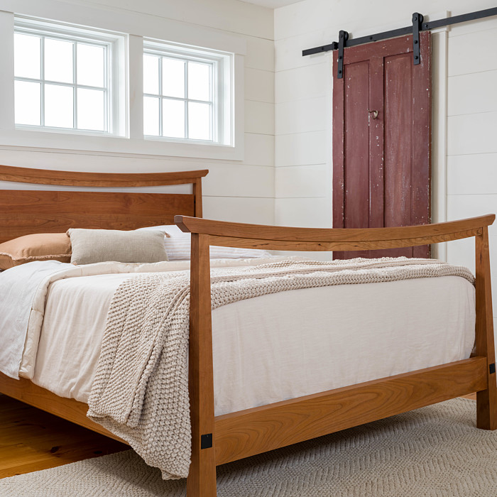 American Bungalow Bed in Cherry in front of a red door