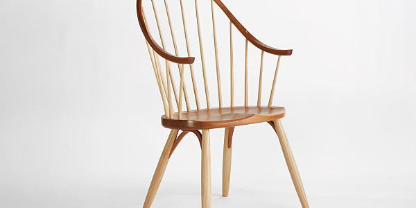 Thos. Moser Continuous Arm Chair on a white background with light shadows.
