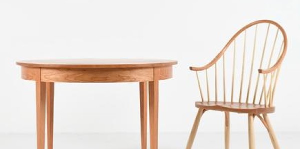 A table and chair set up in a white studio space