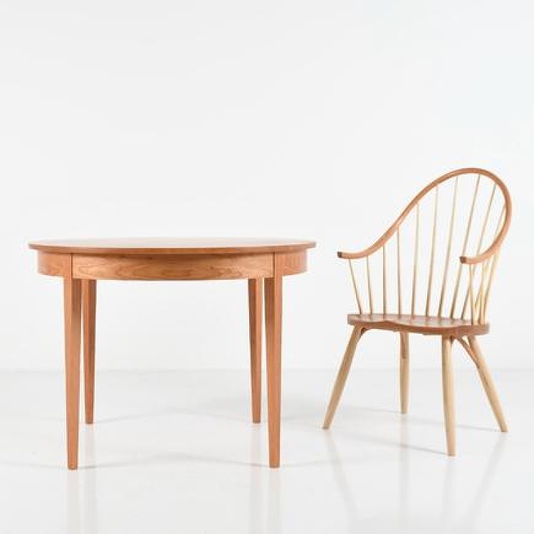 A table and chair set up in a white studio space