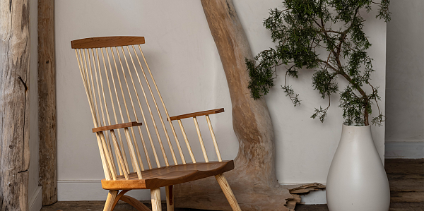 New Gloucester Rocking chair by stairwell, white vase, juniper bough