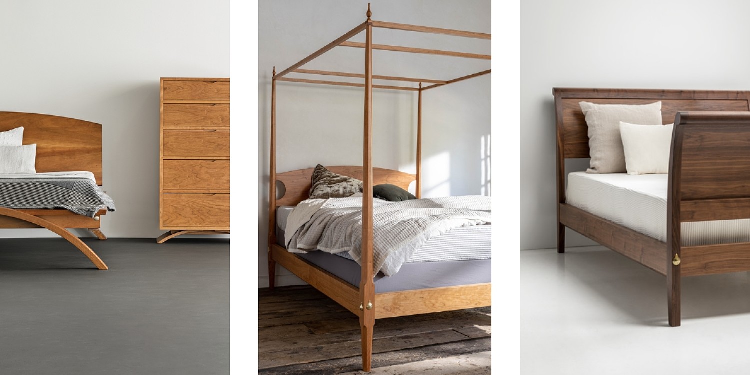 Three beds. Left: Vita bed in cherry. Wooden bed with curved foot made from cherry, a grey blanket and white pillows are on the bed. Beside the bed is a dresser with 5 drawers made from cherry. The dresser has a curved foot. Center: A pencil post bed made of cherry with a canopy top. The bed has white blankets and chocolate colored pillows. Right: The sleigh bed in walnut. The headboard and footboard are curved with a brass bolt cover on the lower leg in the front. The bed has a white fitted sheet and two cream colored linen pillows.